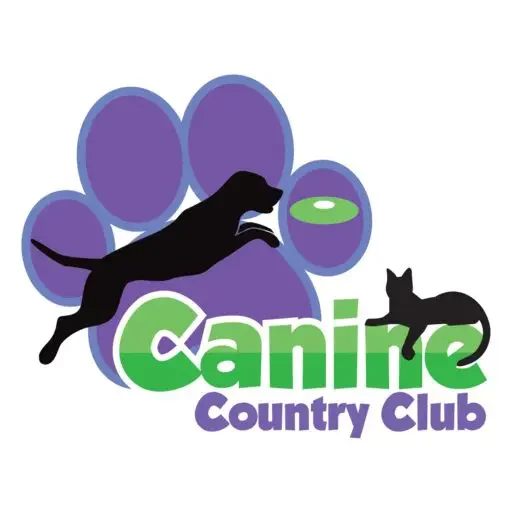 A dog and cat are playing frisbee in front of the canine country club logo.